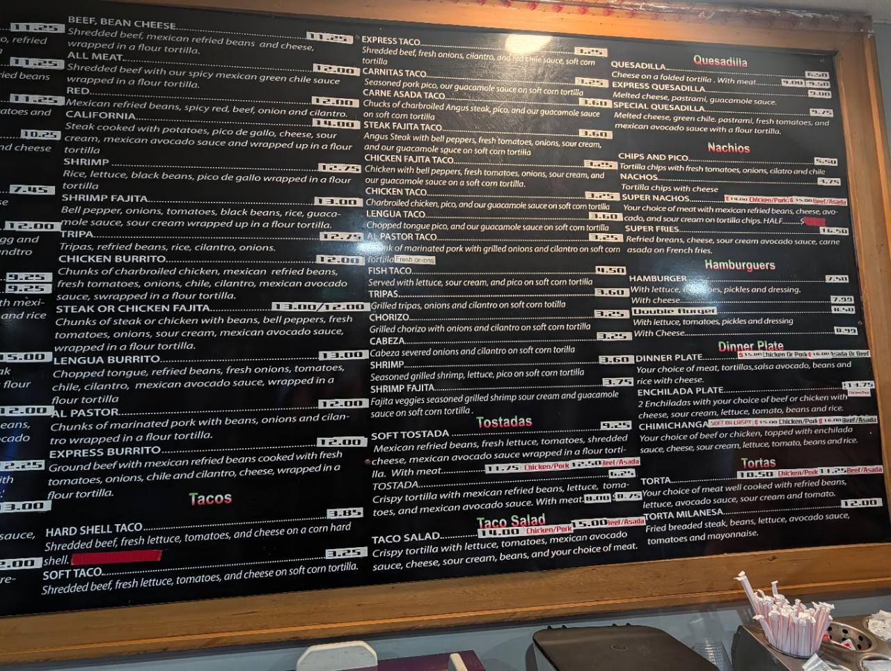 The original wood-framed Super Taco Express menu board inside the restaurant